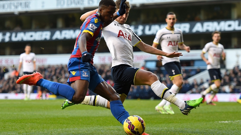 Crystal Palace's Wilfried Zaha crosses the ball under pressure from Ben Davies of Spurs