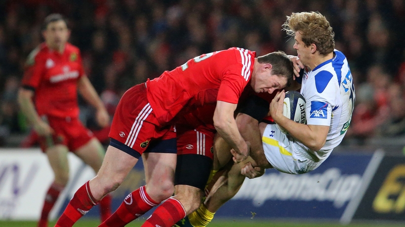 Munster's Denis Hurley and Pat Howard tackle Aurelien Rougerie of ASM Clermont