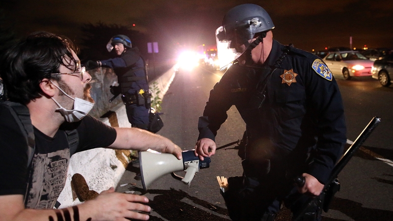 A California Highway Patrol officer confronts a protester who was blocking interstate 80