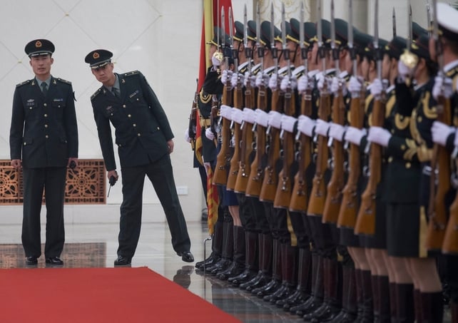 Officers check an honour guard before the start of a welcome ceremony for President Michael D Higgins at the Great Hall of the People in Beijing, China