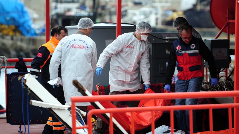 Police carry the body of one of 24 illegal migrants, mostly Afghans, who drowned off the coast of Turkey last month when their boat capsized