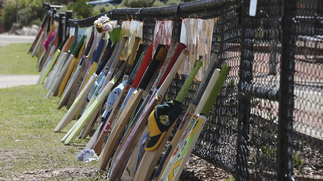 Cricket bats stand as tribute outside a primary school during the funeral of Australian cricketer Phil Hughes in Macksville, Australia