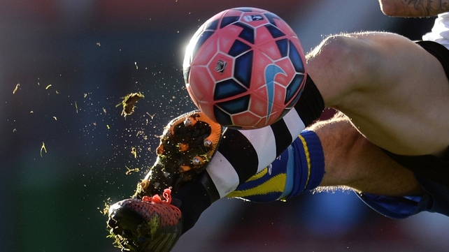 A Gateshead player and a Warrington Town player battle for the ball during the FA Cup Second Round match at the Gateshead International Staduim, Gateshead