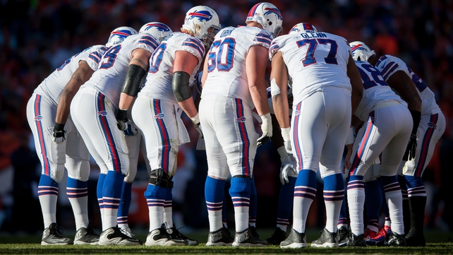 Buffalo Bills players huddle during a game against the Denver Broncos
