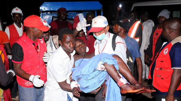 Rescue workers carry an injured victim of Jos bomb blast to Plateau State Specialist Hospital