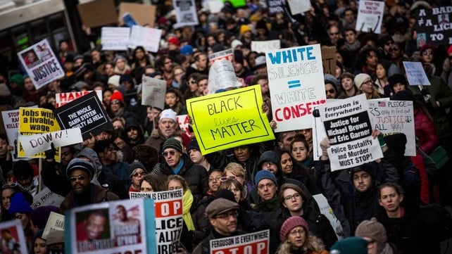 People march through the streets of Manhattan, New York in the National March Against Police Violence