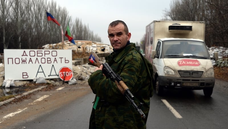 An armed supporter of the self-proclamed People's Republic of Donetsk mans a checkpoint in the city of Horlivka