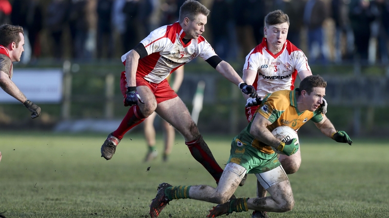 Tir Chonaill Gaels' Gary McGee takes down Corofin's Gary Sice (R)