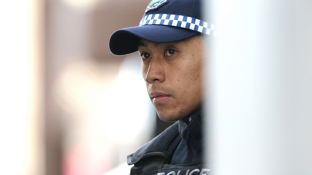 A police officer stands guard in the CBD