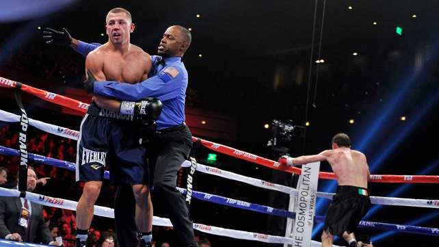 The referee ends the fight as Lee wheels away in celebration