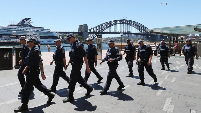 Police walk by the Sydney Harbour Bridge