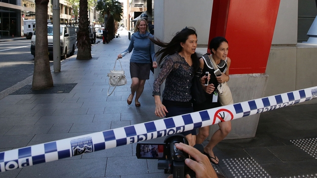 People rush out of Martin place as the area is evacuated