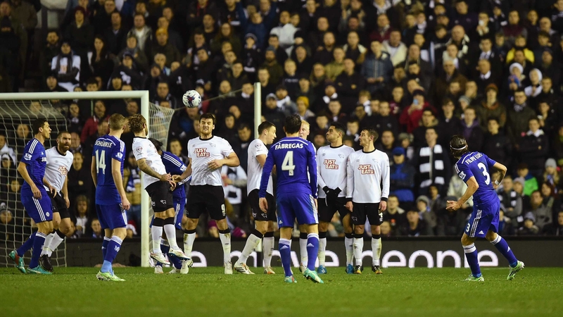 Filipe Luis guides his free-kick over the Derby wall to open his account for Chelsea