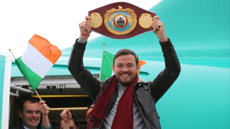 Belt up: Andy Lee departs the plane in Shannon proudly showing off his new acquired WBO World Middleweight belt