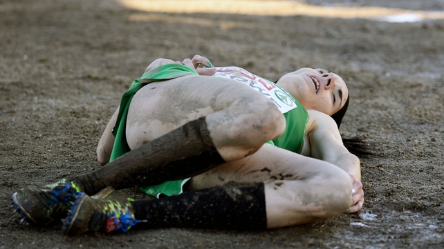 Down but not out: Ireland's Laura Crowe collapses after finishing the European Cross Country Championships in Samokov, Bulgaria