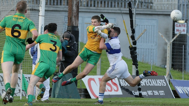 Rhode's Ken Garry bravely saves from the oncoming Shane Carthy of St Vincent's in the Leinster SFC final in Navan