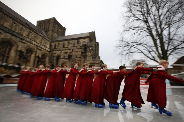 Winchester Cathedral choristers form a train as they hold onto each other during an early morning skate on the ice rink before rehearsals ahead of their busy Christmas singing schedule