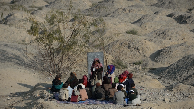 Afghan schoolchildren study at an open-air classroom in the Mohmand Dara district in eastern Nangarhar province