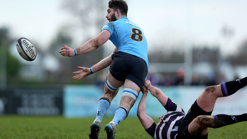 Shen Grannell of UCD passes after being tackled