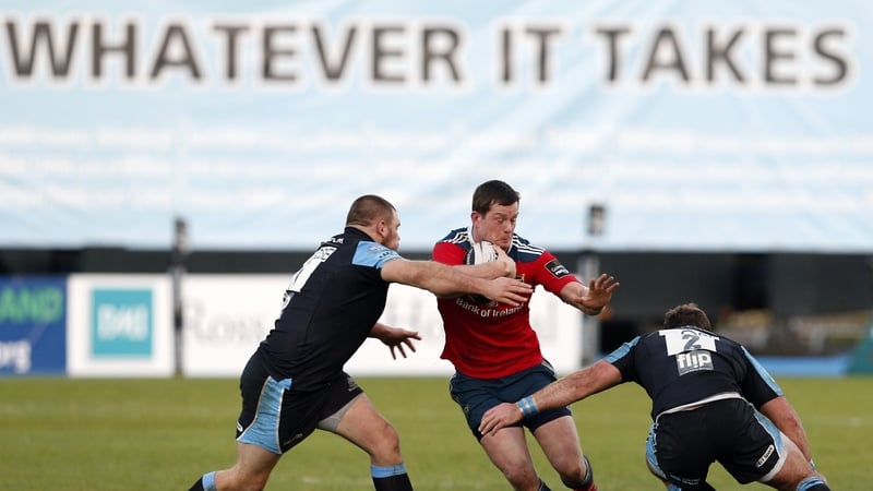 Munster's Denis Hurley is tackled by Warriors' Gordon Reid and Fraser Brown