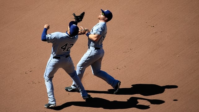 A pop-up casts a shadow as Logan Forsythe and James Loney of the Tampa Bay Rays attempt to make a catch against Baltimore