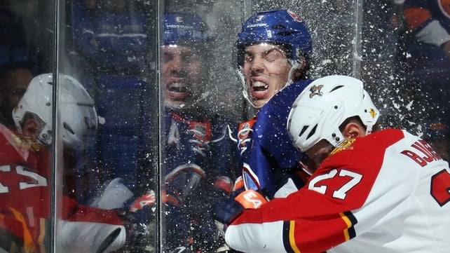 A firm challenge on Travis Hamonic of the New York Islanders during the Nassau Veterans Memorial