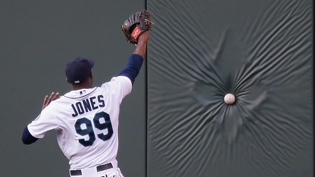 James Jones of Seattle fails to reach a fly ball against LA in Anaheim