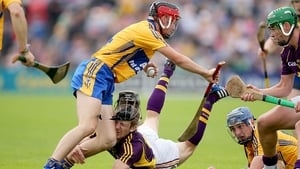 Wexford's Liam Og McGovern takes a hit from the knee of Jack Browne of Clare