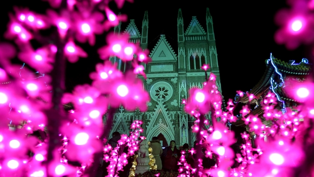 Lights decorate the Xishiku Catholic church during a Christmas Eve mass in Beijing, China