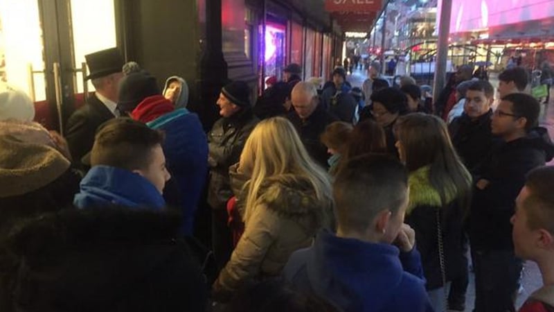 Shoppers queue outside Arnotts in Dublin for bargains