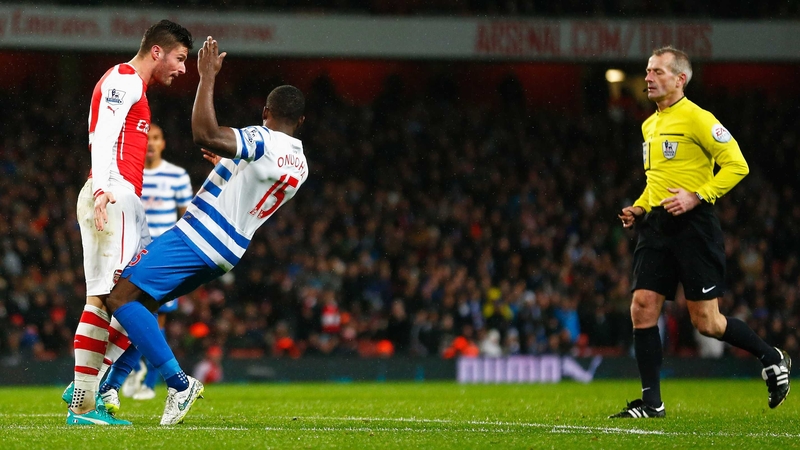 Olivier Giroud of Arsenal head butts Nedum Onuoha of QPR before being sent off by referee Martin Atkinson