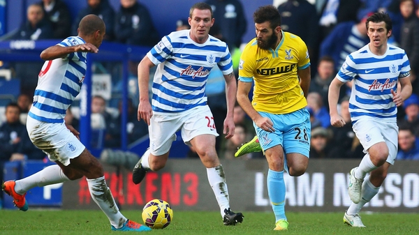 Joe Ledley of Crystal Palace takes on Karl Henry (left), Richard Dunne (second left) and Joey Barton (right) of QPR