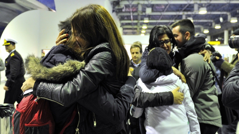 Survivors and relatives are reunited after arriving at the port of Igoumenitsa in northern Greece