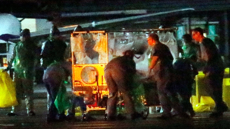 A healthcare worker is taken on board a plane at Glasgow Airport as she is moved to the Royal Free Hospital in London