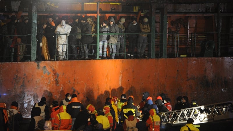 Migrants wait aboard the Moldovan-flagged ship Blue SKy M in the port of Gallipoli
