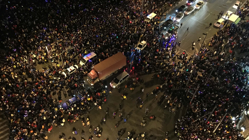 Witnesses said people rushed to pick up fake money being thrown from a building overlooking the Bund