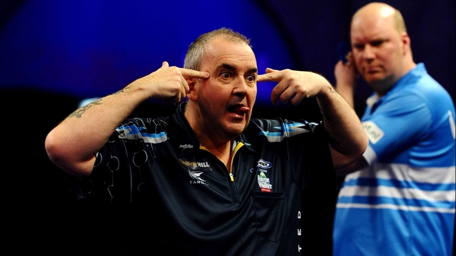 Phil Taylor reacts after winning a set during his match against Vincent van der Voort at the 2015 William Hill PDC World Darts Championships at Alexandra Palace