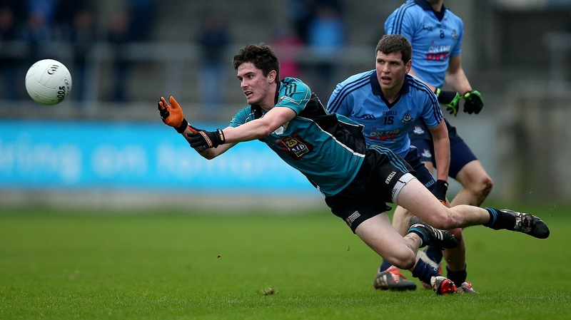 Maynooth's David Hyland with Niall Collins of Dublin