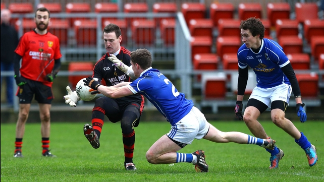 Cavan's Joshua Hayes closes down Down 'keeper Stephen Kane in the McKenna Cup
