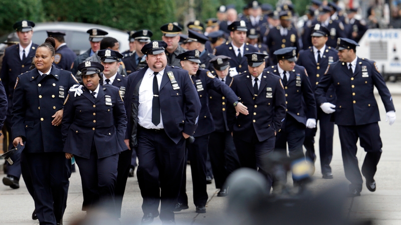 Police officers arrive at the wake of Wenjian Liu, outside the Aievoli Funeral Home in Brooklyn