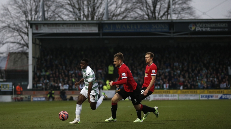Yeovil Town defender Seth Nana Twumasi (L) is closed down by Manchester United's Luke Shaw