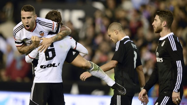 Valencia's Argentinian defender Nicolas Otamnedi (C) and Valencia's Argentinian defender Lucas Orban celebrate their victory over Real Madrid at the Mestalla stadium in Valencia