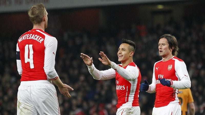 Arsenal's Per Mertesacker (L) celebrates scoring the opening goal with Alexis Sanchez Tomas Rosicky (R)
