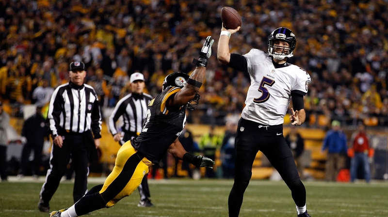 Joe Flacco of the Baltimore Ravens throws under pressure from the Pittsburgh Steelers' James Harrison
