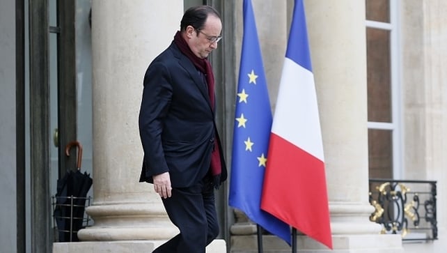 French president Francois Hollande leaves the Palais de l'Elysee to go to the scene of the shooting