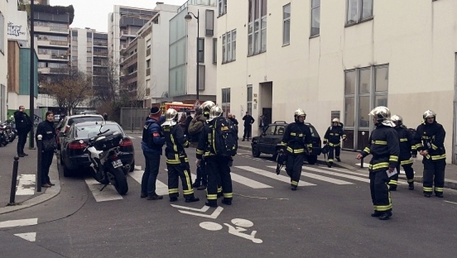 Police officers and firefighters gather at the scene