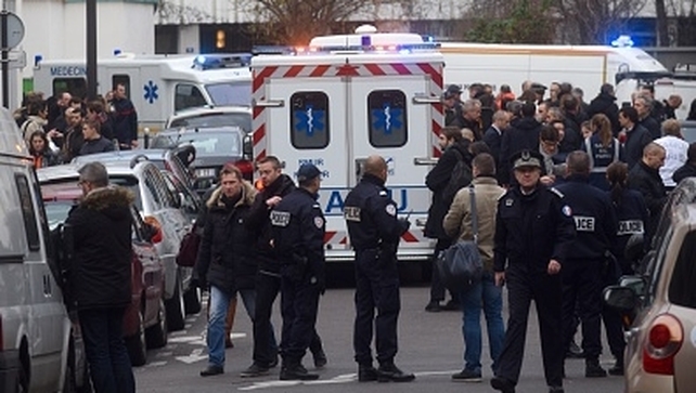 Ambulances and police officers gather at the scene of the attack