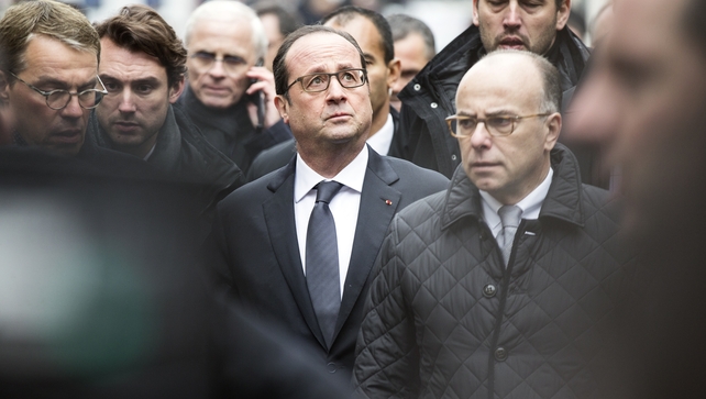 French President Francois Hollande and Interior Minister Bernard Cazeneuve arrive at the scene of the shooting in Paris