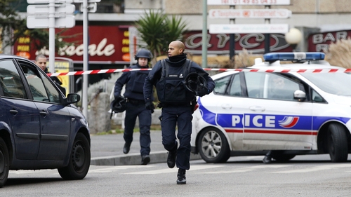 Police officers carry out an operation in Arcueil, near Paris following a the shooting in Montrouge