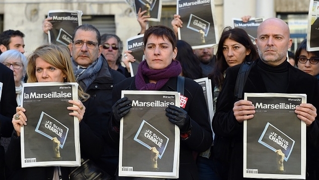 French journalists of the regional newspaper "La Marseillaise" gather to pay tribute to the people who lost their lives